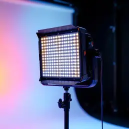 Professional bi-color LED panel on light stand showing warm to cool temperature gradient in modern photography studio