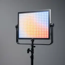 Professional bi-color LED light panel on studio stand showing warm orange to cool blue gradient with visible adjustment dial