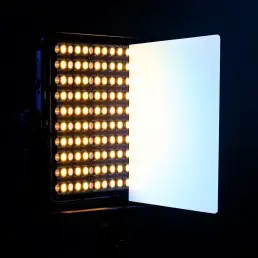 Professional bi-color LED panel displaying warm tungsten and cool daylight with color temperature card in studio setup