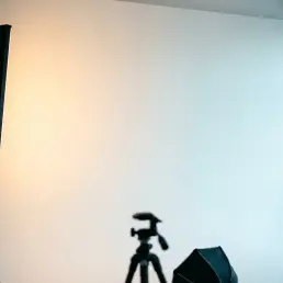 Bi-colour LED panel casting a warm amber to cool daylight gradient across a white studio cyclorama backdrop.